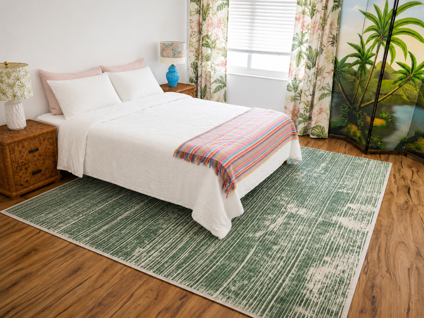 Tropical bedroom with white bedding, palm-print textiles, and a painted screen